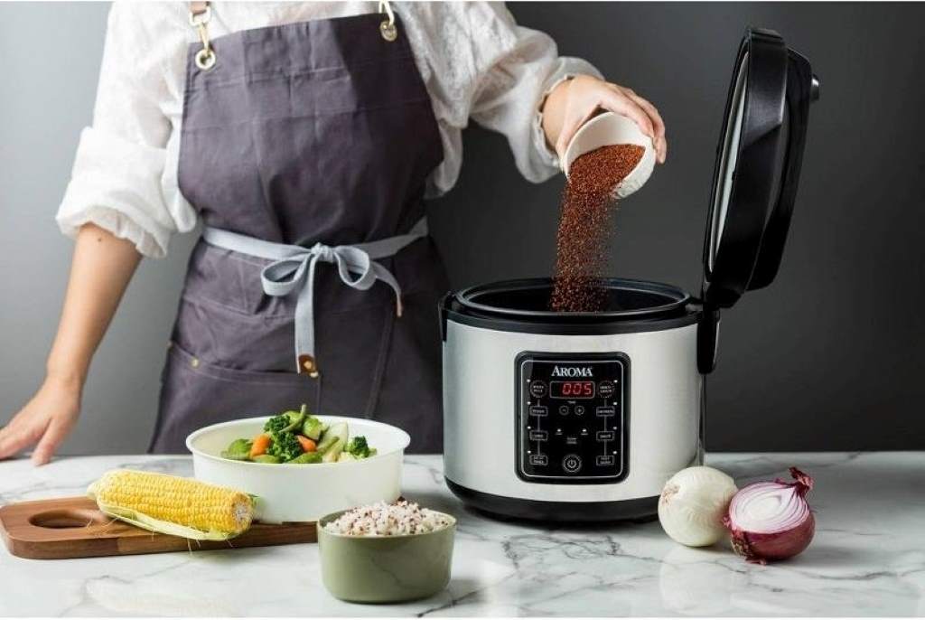 Aroma 2-Cup rice cooker with steaming rice and vegetables on tray