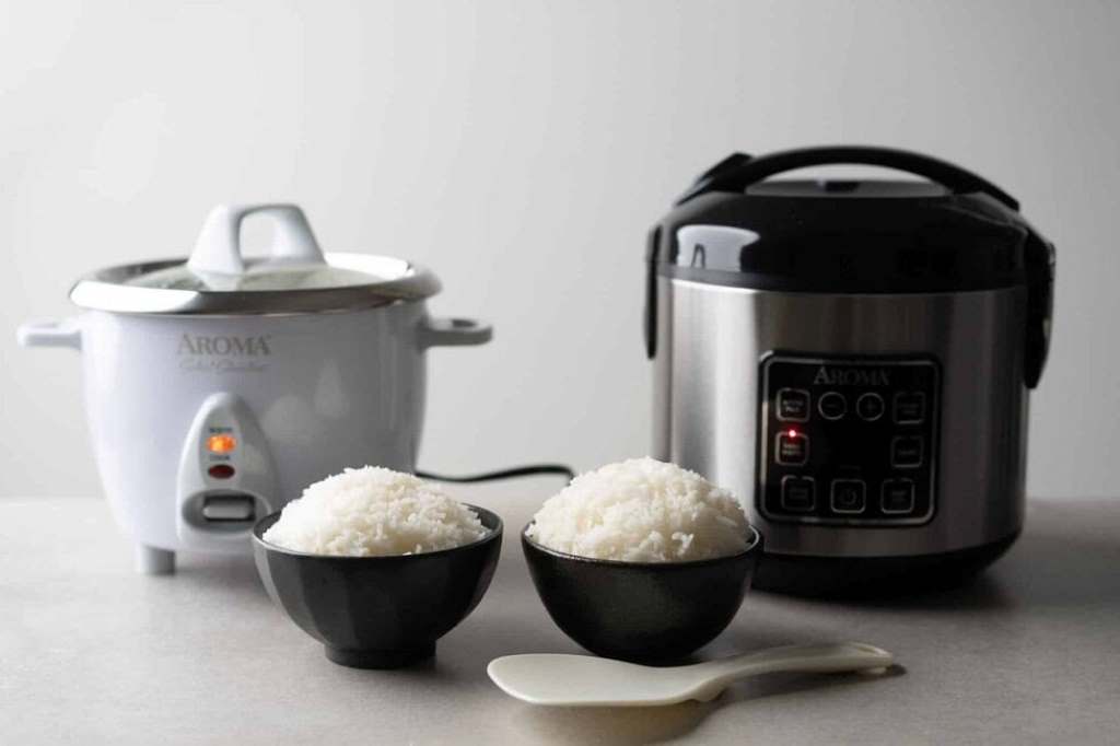 Person using Aroma 2-Cup rice cooker to prepare a healthy one-pot meal