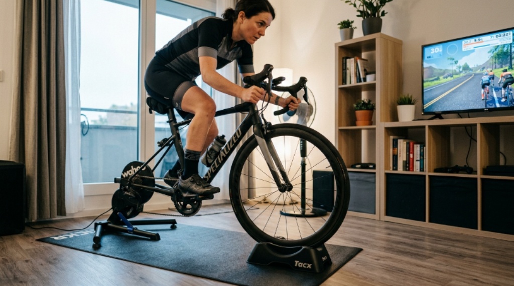 Indoor cyclist using a wheel riser block for wheel support and level riding position
