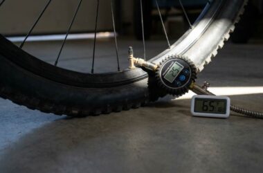 Cyclist checking bicycle tire pressure before riding