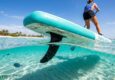 Paddleboarder gliding over clear Florida waters with a durable SUP fin.