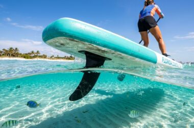 Paddleboarder gliding over clear Florida waters with a durable SUP fin.